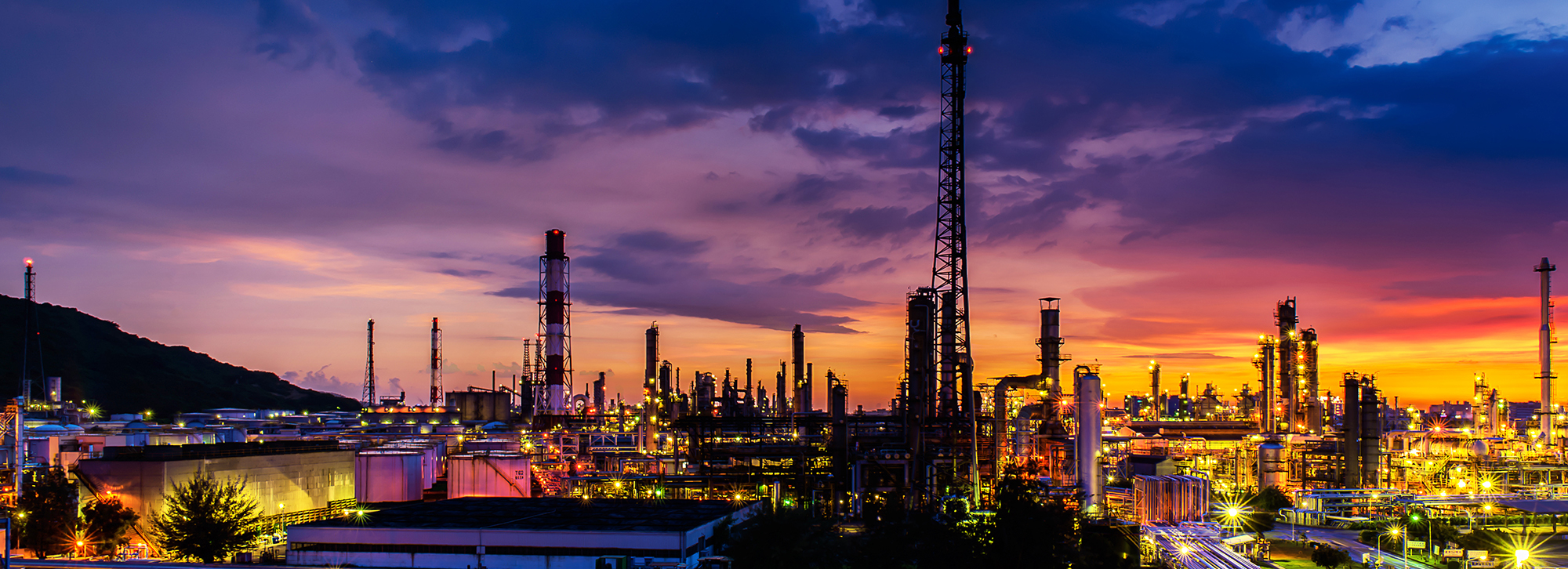 gas plant lit up at dusk